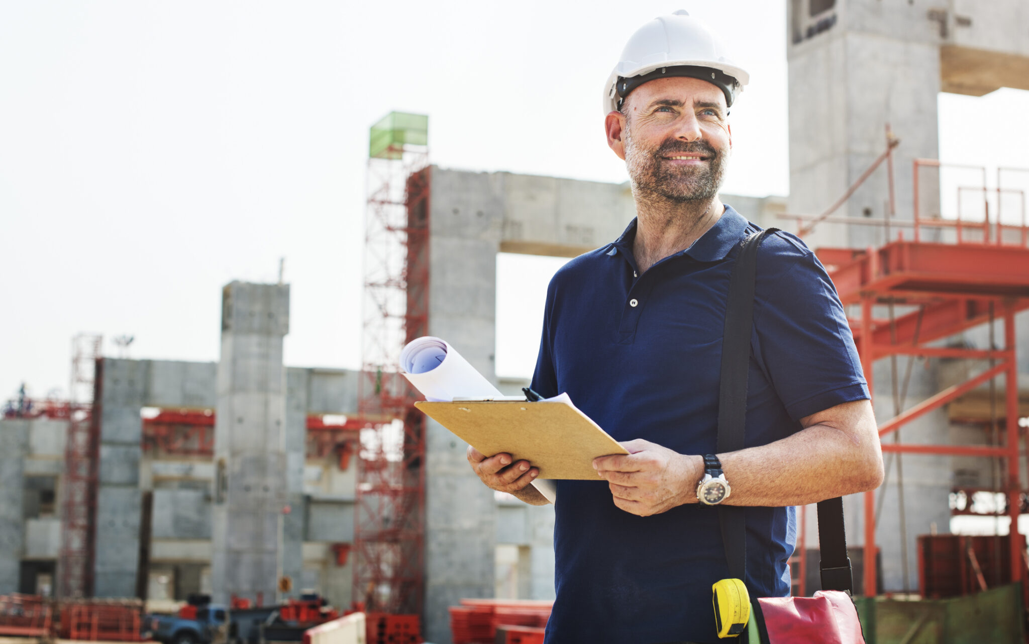 Construction worker reviewing plans on-site | IONYX digital